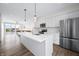 Open concept kitchen with stainless steel appliances, a center island, and an adjacent living area at 806 7Th St, Columbus, IN 47201