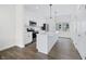 Modern kitchen featuring white cabinets, stainless steel appliances, and a spacious island with pendant lighting at 806 7Th St, Columbus, IN 47201