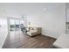 Open living area featuring hard surface floors, neutral furnishings, and bright balcony access at 806 7Th St, Columbus, IN 47201