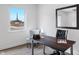 Well-lit office space featuring a minimalist desk, neutral chair, and large window view at 806 7Th St, Columbus, IN 47201