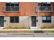 Modern townhomes with red brick and neutral accents, complemented by young trees and tidy landscaping at 806 7Th St, Columbus, IN 47201