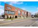 Street-level view of modern townhouses, featuring brick exteriors, manicured lawns, and inviting curb appeal at 806 7Th St, Columbus, IN 47201