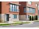 Close-up of brick townhouses with balconies, modern awnings, and professionally landscaped lawns at 806 7Th St, Columbus, IN 47201