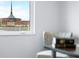 This serene window view shows a church steeple with plenty of natural light, and view of parking lot at 806 7Th St, Columbus, IN 47201