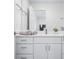 Bright bathroom featuring a vanity with a white countertop, storage, and a plant for a touch of nature at 822 7Th St, Columbus, IN 47201