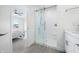 Bright bathroom featuring a glass-enclosed shower and access to the main bedroom at 822 7Th St, Columbus, IN 47201