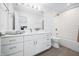 Bright bathroom with a large mirror, white cabinets, modern fixtures and a shower and bathtub combination at 822 7Th St, Columbus, IN 47201