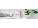 Bright bathroom featuring a modern faucet, clean white countertop, and greenery at 822 7Th St, Columbus, IN 47201