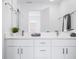 Bright bathroom featuring double sinks, white cabinets, modern fixtures and a large mirror at 822 7Th St, Columbus, IN 47201