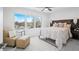 Bright bedroom with a large window, neutral carpet, and a decorative ceiling fan at 822 7Th St, Columbus, IN 47201