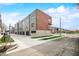 Modern townhomes with tan siding, red brick, and individual garages at 822 7Th St, Columbus, IN 47201
