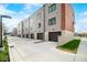 New townhouse with neutral siding, red brick accent, and garages at 822 7Th St, Columbus, IN 47201