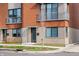 Detailed exterior view of brick townhome, highlighting private entrance, balcony, and modern design elements at 822 7Th St, Columbus, IN 47201