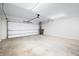 Spacious two car garage featuring a large door with opener, concrete floor and ample lighting at 822 7Th St, Columbus, IN 47201