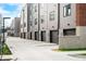View of modern townhome garages, showing clean design and tidy landscaping at 822 7Th St, Columbus, IN 47201