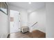 Hallway with wood floors, pouf, and doorway to the bedroom at 822 7Th St, Columbus, IN 47201