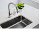 Close up on kitchen sink and countertops with decor and natural light at 822 7Th St, Columbus, IN 47201