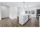 Open kitchen showcases a center island, gray laminate floors, and stainless appliances at 822 7Th St, Columbus, IN 47201