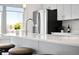 Bright kitchen featuring a quartz countertop, steel sink, and stainless steel fridge at 822 7Th St, Columbus, IN 47201
