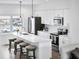 Stylish kitchen with white cabinets, a stainless refrigerator, and seating at the island at 822 7Th St, Columbus, IN 47201