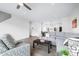 Bright living room with gray L-shaped couch, ceiling fan, wood floors and open floor plan at 822 7Th St, Columbus, IN 47201