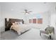 Comfortable main bedroom featuring a padded headboard, ceiling fan, large windows and lots of natural light at 822 7Th St, Columbus, IN 47201