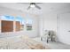 Comfortable main bedroom featuring a ceiling fan, large windows and a view at 822 7Th St, Columbus, IN 47201