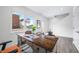 Bright office with wooden desk, modern decor, and a large window offering natural light and street views at 822 7Th St, Columbus, IN 47201