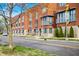 Street-level view of townhomes, street signs, and crosswalk with landscaped front yards at 822 7Th St, Columbus, IN 47201
