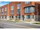 Street view of modern townhomes with brick exteriors, showcasing balconies and fresh landscaping at 822 7Th St, Columbus, IN 47201
