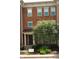 Charming brick townhome featuring a covered entryway and well-maintained landscaping at 6343 Central Blvd, Whitestown, IN 46075
