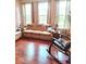 Comfortable living room showcasing hardwood floors, large windows, and a rocking chair at 6343 Central Blvd, Whitestown, IN 46075