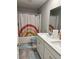 Bright bathroom featuring double vanity, tiled floor, and rainbow-themed shower curtain at 696 Scarsdale Ln, Danville, IN 46122