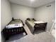 Cozy bedroom featuring two twin beds with gray walls and carpet, lit by a recessed light at 696 Scarsdale Ln, Danville, IN 46122