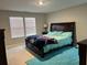 Comfortable bedroom with a large bed, bright windows and a soft blue rug at 696 Scarsdale Ln, Danville, IN 46122