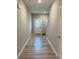 Clean, bright hallway with hard surface flooring, leading to rooms and stairs at 696 Scarsdale Ln, Danville, IN 46122