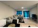 Cozy living room features a plush sectional sofa, area rug, and bright teal curtains at 696 Scarsdale Ln, Danville, IN 46122