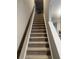 Carpeted stairs with modern railing provide access to upper floors at 696 Scarsdale Ln, Danville, IN 46122