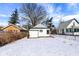 Backyard with snow featuring the garage and trees at 5845 Rawles Ave, Indianapolis, IN 46219