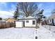 Backyard with snow featuring the garage and trees at 5845 Rawles Ave, Indianapolis, IN 46219