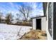 Backyard with snow featuring the garage and trees at 5845 Rawles Ave, Indianapolis, IN 46219