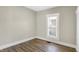 Cozy room featuring wood-look floors, and a window with natural light at 5845 Rawles Ave, Indianapolis, IN 46219