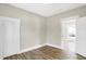 This bedroom has newer wood floors, white doors and neutral paint colors at 5845 Rawles Ave, Indianapolis, IN 46219