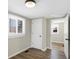 This bedroom features wood floors, neutral paint and two bright windows at 5845 Rawles Ave, Indianapolis, IN 46219