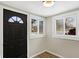 Bright entry featuring hardwood floors, fresh paint, and two large windows at 5845 Rawles Ave, Indianapolis, IN 46219