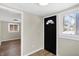 Welcoming entry with new hardwood floors, freshly painted walls and natural lighting at 5845 Rawles Ave, Indianapolis, IN 46219