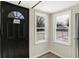 Inviting entryway with wood-look floors and lots of natural light from the windows flanking the front door at 5845 Rawles Ave, Indianapolis, IN 46219