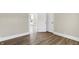 Bright room featuring wood-look floors, and a window with natural light at 5845 Rawles Ave, Indianapolis, IN 46219