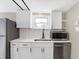 A close-up shot of the white kitchen with stainless steel appliances and fixtures at 5845 Rawles Ave, Indianapolis, IN 46219