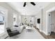 Modern living room with white sofa and decor, open layout and bright natural light at 5845 Rawles Ave, Indianapolis, IN 46219